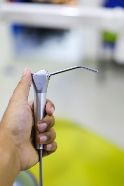 Cropped hand of person holding dental surgery equipment