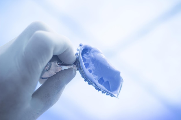 Photo cropped hand of person holding dentures