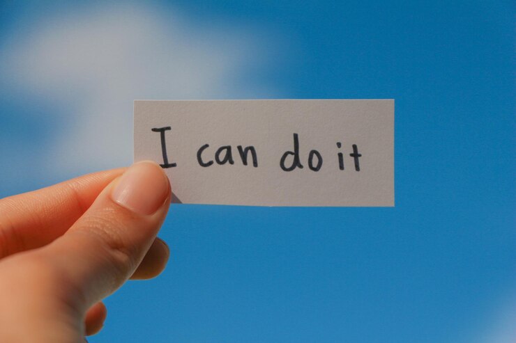 Photo cropped hand of person holding paper with text against sky