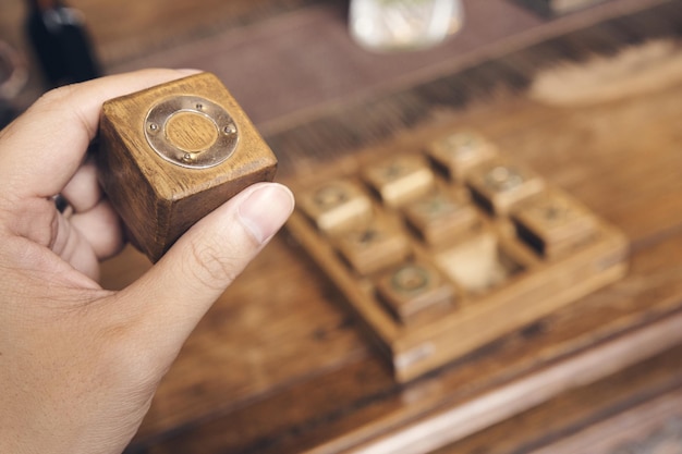 Cropped hand of person holding wooden block