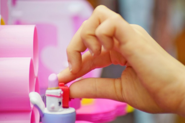 Photo cropped hand of person playing with toy at home