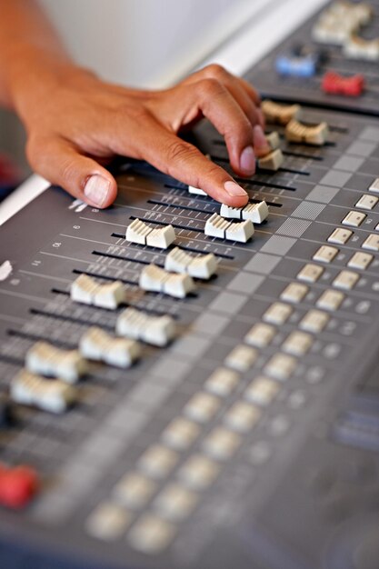 Photo cropped hand of person using music mixer