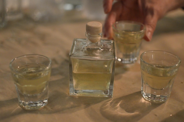 Cropped hand of person with drink on table