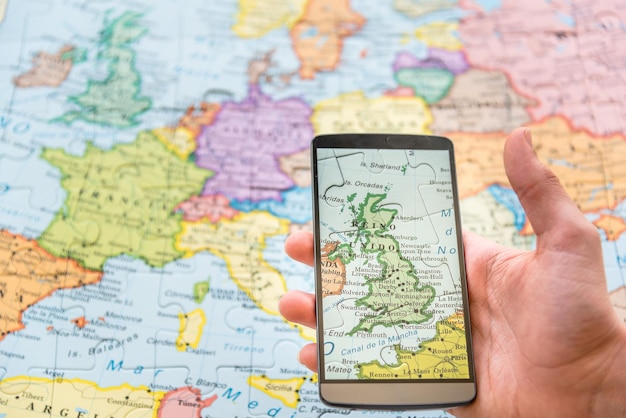 cropped hand photographing map using smart phone