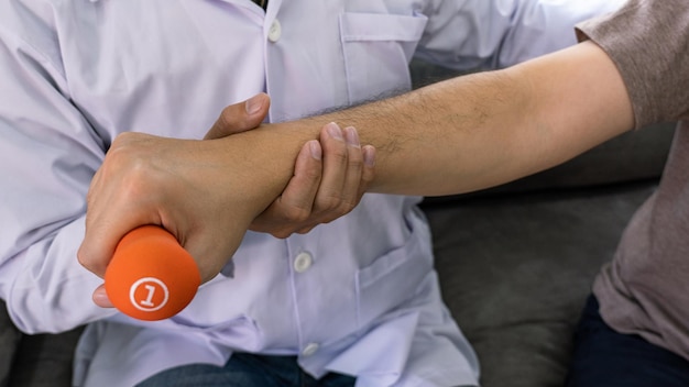 Foto mano tagliata di un fisioterapeuta che assiste un paziente in una clinica medica