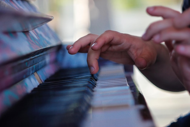 Photo cropped hand playing piano