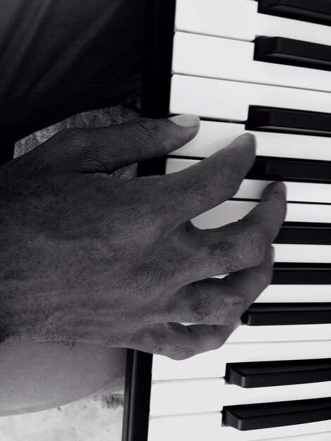 Photo cropped hand playing piano