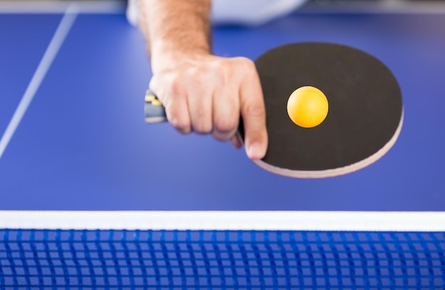 cropped hand playing table tennis