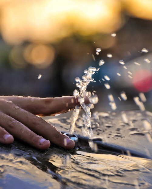 Foto mano tagliata che gioca con l'acqua