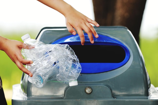 Cropped hand putting garbage in bin