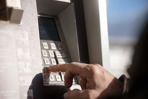 Cropped hand using atm machine