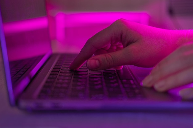 cropped hand using laptop