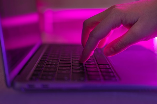 cropped hand using laptop