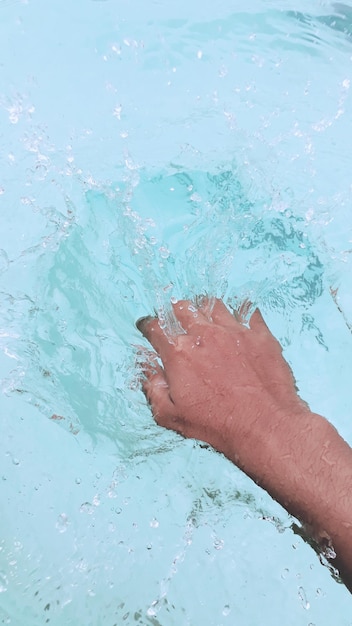 Cropped hand in water