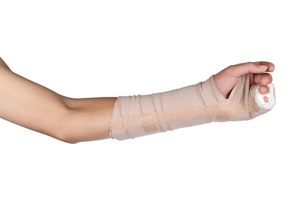 Cropped hand wearing adhesive bandage against white background