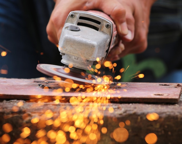 Cropped hand welding metal