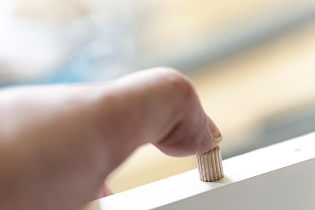 Photo cropped hand on window sill