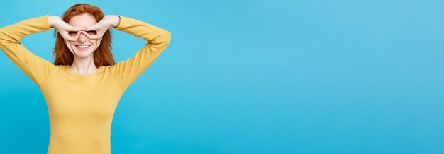 Cropped hand with arms raised against blue background