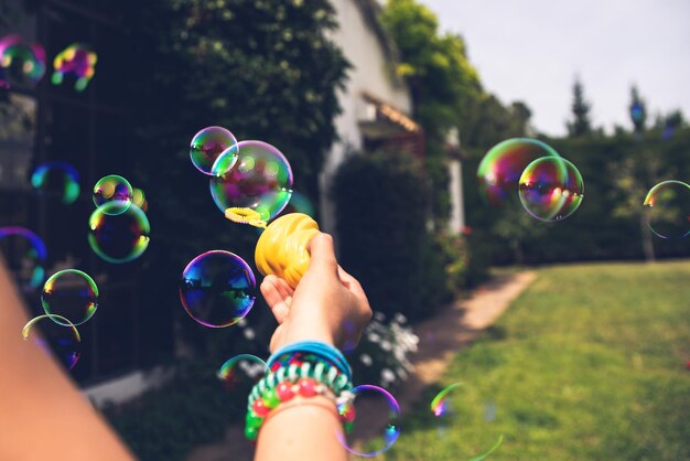 Photo cropped hand woman holding bubble wand