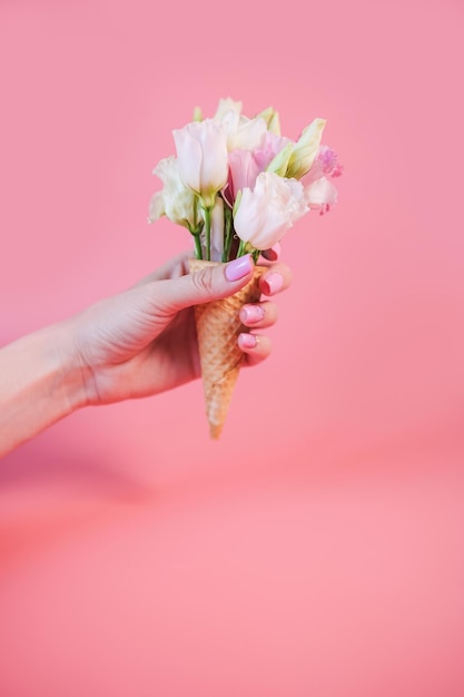 Cropped hand of woman holding flower