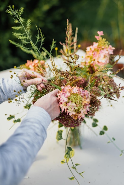 Cropped hand of woman holding flowering plant