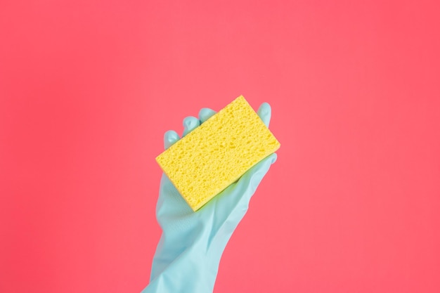 Cropped hand of woman holding gift against yellow background