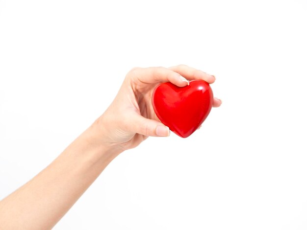 Photo cropped hand of woman holding heart shape against white background