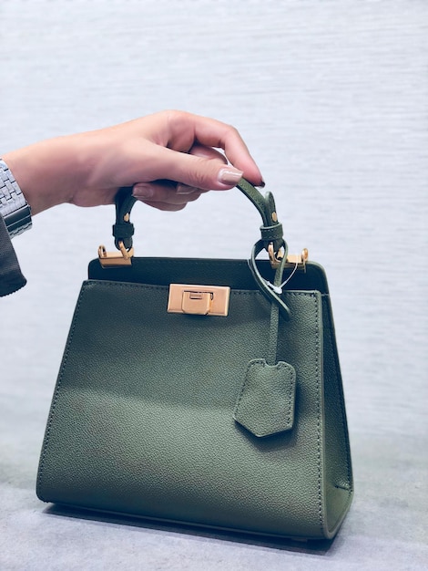 cropped hand of woman holding purse