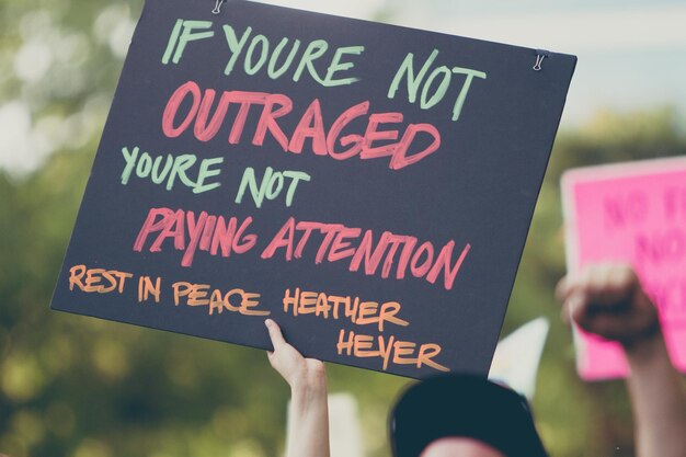 Cropped hand of woman holding text on paper