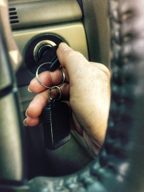 Photo cropped hand of woman turning in car ignition