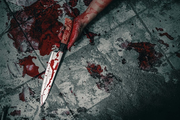 Cropped hand of woman with blood on floor