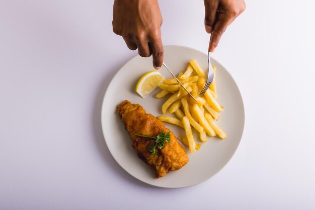 Photo cropped hands of african american man having french fries and seafood, copy space