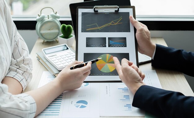 Cropped hands of business colleagues working on table