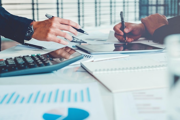 Cropped hands of business people working at table