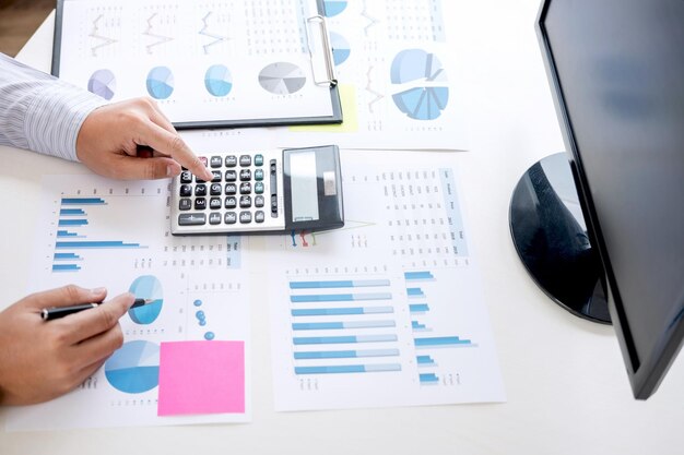 Cropped hands of businessman working at desk in office