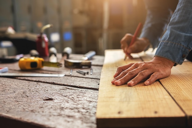 cropped hands of carpenter working at workshop