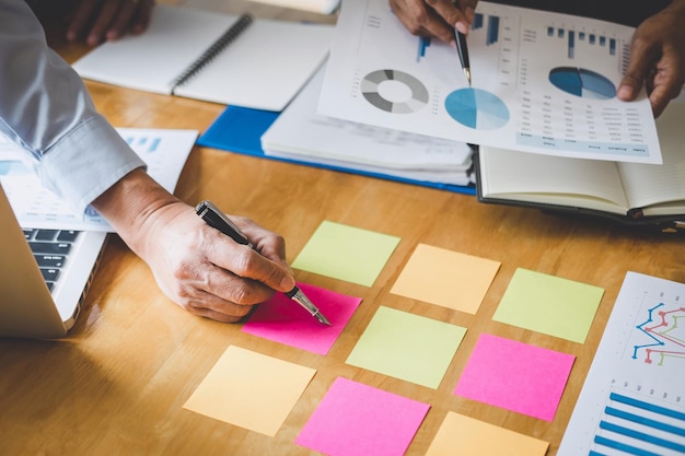 Photo cropped hands of coworkers discussing on desk in office