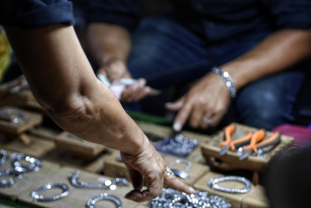 Photo cropped hands gesturing over metal