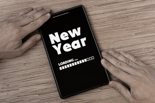 Cropped hands holding digital tablet with message on table