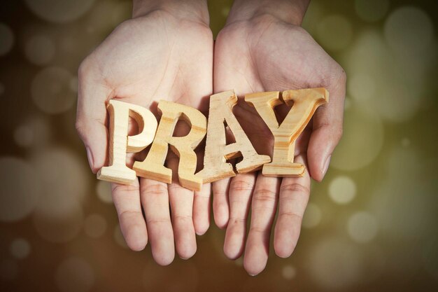 Photo cropped hands holding pray text