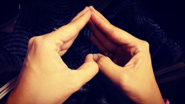 Photo cropped hands making heart shape