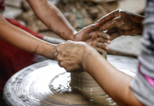 Photo cropped hands making pot