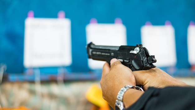 Photo cropped hands of man target shooting