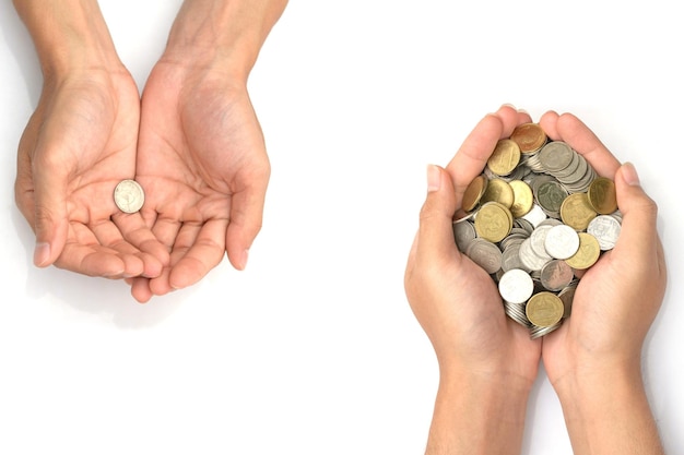 Cropped hands of people holding coins over white background