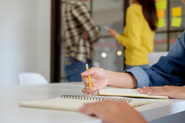 Cropped hands of people studying in library