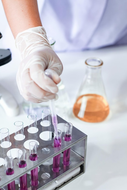 Cropped hands of person analyzing chemical in laboratory