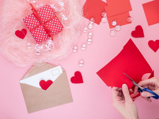 Cropped hands of person cutting paper on table