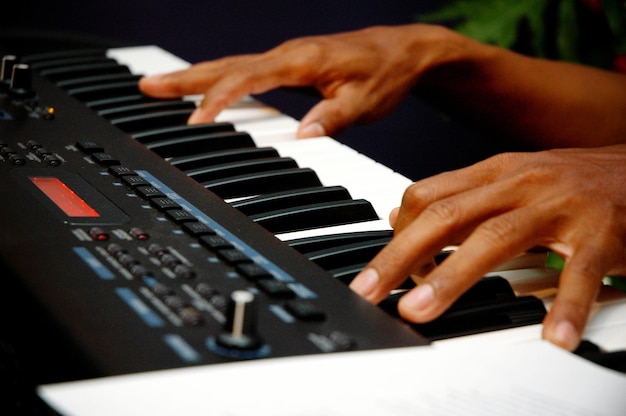 Cropped hands of person playing piano