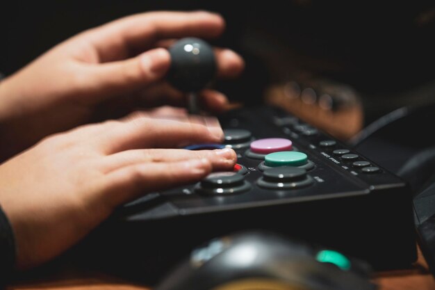 Photo cropped hands of person using game controller