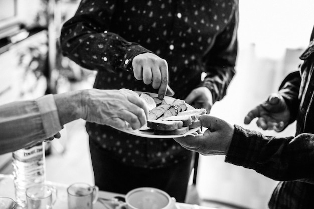 Cropped hands picking food from plate